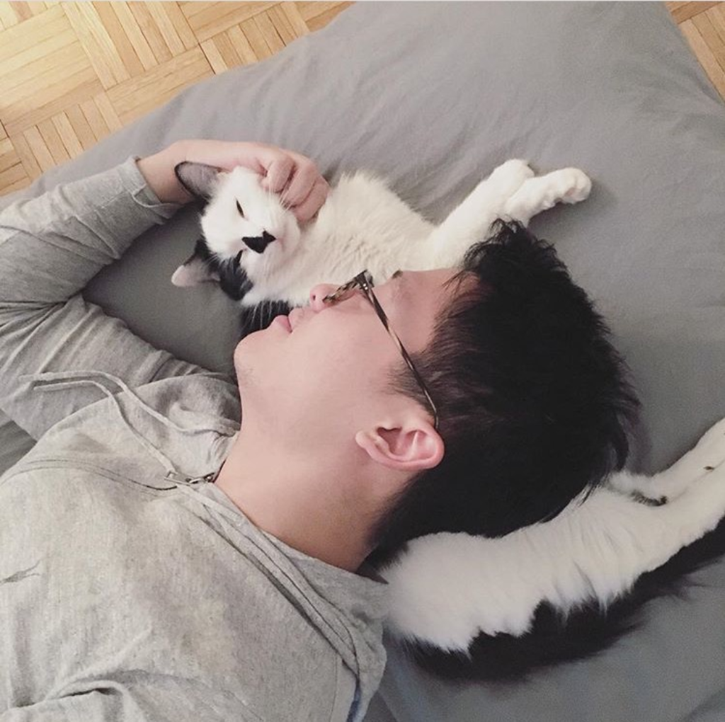 man snuggles with cat